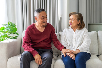 Senior happy love asian senior couple relaxing and talking together lying on sofa in bedroom at home, wife, family, elderly, care, health, insurance.Retirement healthcare couple concept
