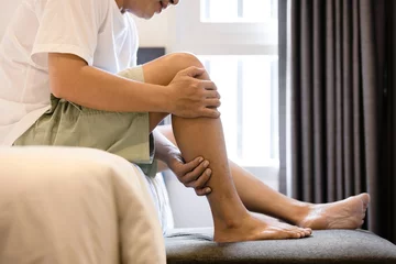 Fotobehang Oude deur Asian middle aged man have severe cramp his calf of leg,muscle strain,adult male massaging leg with his hands,suffering from muscle cramps,contraction of muscles or tendons,physical injury,health care