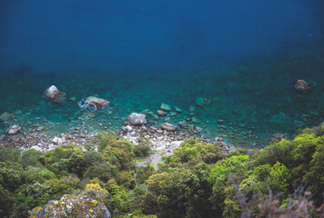 stone in turquoise water , Blue sea