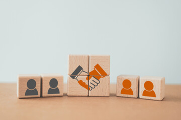 business contract. hand shaking icon on wooden cube blocks and blurred human icon for business deal...
