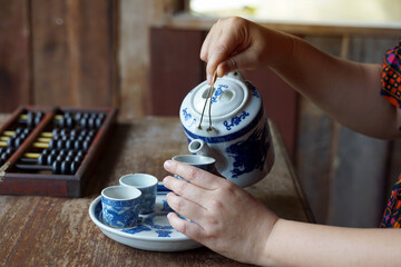 A photo corner that simulates the tea culture of the Chinese people. with Asian women playing...