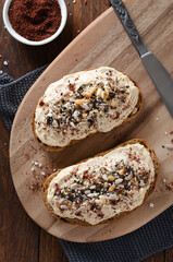 Hummus Toast with Rustic Bread, Vegetarian Snack or Breakfast on Wooden Background