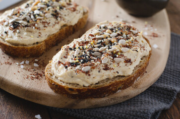 Hummus Toast with Rustic Bread, Vegetarian Snack or Breakfast on Wooden Background