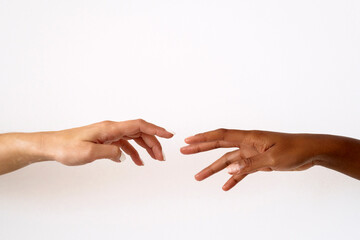 Cropped image of friends reaching to each other against white background