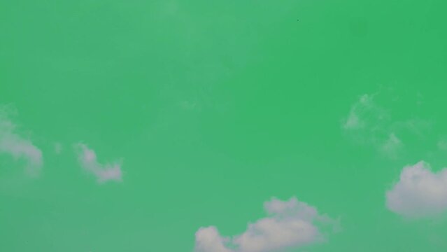 The green screen of moving white clouds with 4K resolution. Can use to change the background color.