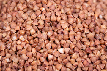 Pile of buckwheat grains as background, spice or seasoning as background. close-up buckwheat