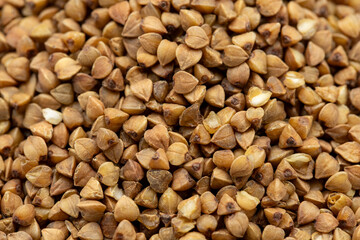 Pile of buckwheat grains as background, spice or seasoning as background. close-up buckwheat