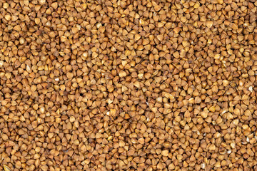 Pile of buckwheat grains as background, spice or seasoning as background. close-up buckwheat