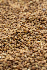 Pile of buckwheat grains as background, spice or seasoning as background. close-up buckwheat