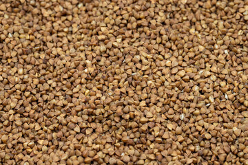 Pile of buckwheat grains as background, spice or seasoning as background. close-up buckwheat