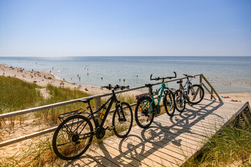 Fototapeta na wymiar Bicycles parked near the beach in a row. Summer activity and summer journey concept.