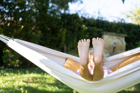 Girl With Feet Up Relaxing In Hammock