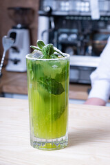 Mojito cocktail on the bar counter in the cafe. Summer fresh alcoholic drink.