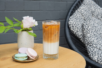 Iced latte coffee in glass on cafe table background. Summer fresh coffe drink