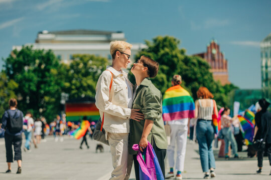 Loving lesbian couple embracing each other at gay pride event