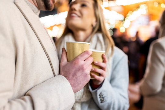 Happy couple with coffee cup at Christmas market 