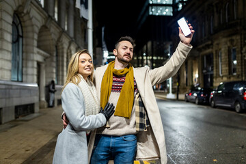 Smiling woman with man hailing for ride on road