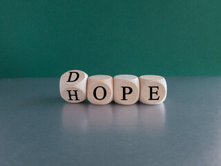 Turned a dice as symbol to have hope instead of dope. Beautiful green background, grey table, copy space.