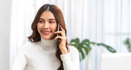 Portrait of smiling happy beauty asian business woman relaxing using digital technology smartphone.Young asian girl work call and talk with friend business team at home