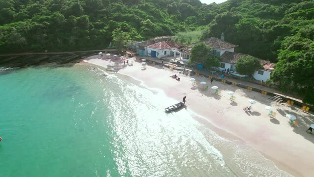 Azeda small empty crescent beach aerial view over calm clear shimmering turquoise ocean
