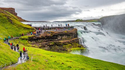 Wonderful waterfall Gullfoss, Golden waterfall in South West Iceland, with many tourists - obrazy, fototapety, plakaty