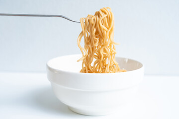 Eat instant noodles in a cup with a fork.