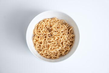 Instant noodles in a white bowl isolated on white background