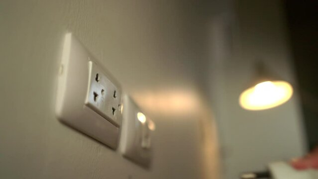 Hand holding Electric plug put on multiple socket. Electrical equipment, electrical wires and power strips in the house. Earth Hour saving electrical energy.
use. Earth Hour saving electrical energy.
