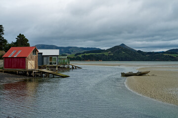 Fototapeta na wymiar Boatsheds at Papanui inlet on the Otago Peninsula