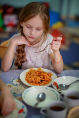 Kindergarten. Junior School. Lunch at the little schoolchildren. Little schoolchildren. Kindergarteners. Children. Friends. Studies. Food in the dining room. Soup. Fried cabbage. The children are havi