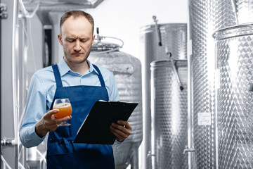 Quality control beer mead, worker tests and evaluates taste of drink at brewery