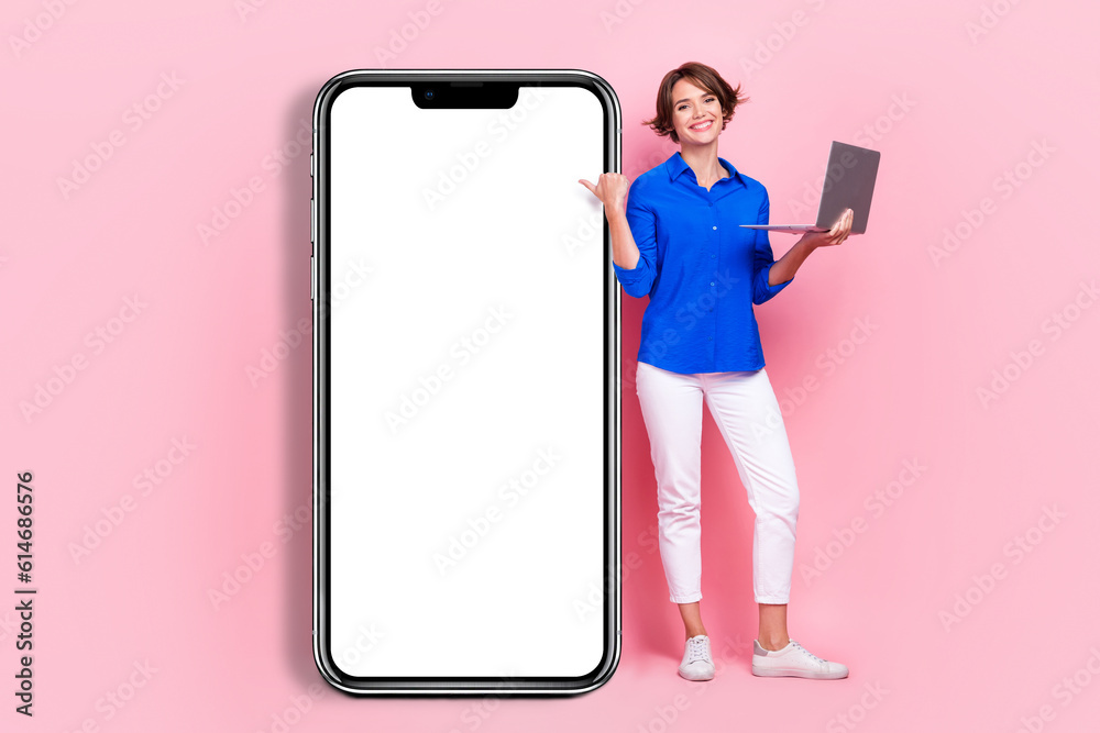 Sticker Full body length size photo of positive entrepreneur beautiful woman hold netbook directing finger phone display isolated on pink color background