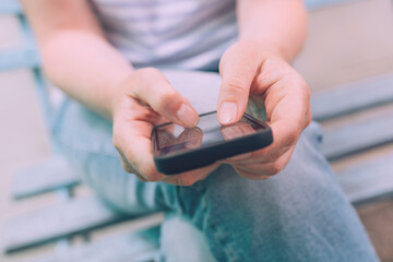 Fear of missing out (Fomo) concept, closeup of female hands using mobile smart phone