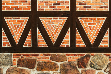 Half-timbered old house wall, brick wall pattern with joist timber framework. Detail from town of...