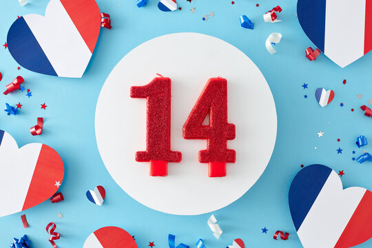 Party concept for celebrating French Bastille Day. Top view arrangement of hearts decorations in national colors, confetti and circle with number 14 candle on light blue background - Powered by Adobe