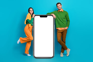 Full length photo of two people advertise smart board internet shopping smart gadgets isolated blue...