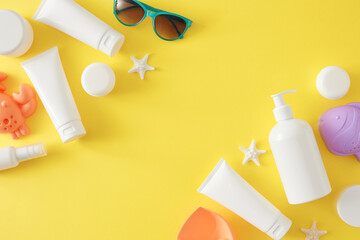 Concept for kids' summer skincare routine. Top view flat lay of sunscreen mockup, eyewear, summer toys, starfish on yellow background with blank space for promo or ads