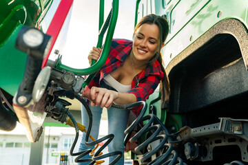 female junior driver checks the truck's equipment, practices safe driving and follows safety...