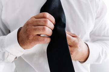 Executive manger businessman adjusting his tie for his job