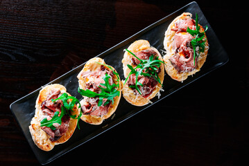 bruschetta with roast beef and cheese on plate