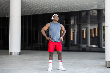 portrait of a handsome african man in sportswear wearing headphones