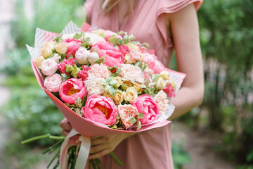 Beautiful bouquet with peonies flowers in woman hand. Floral shop concept . Beautiful fresh cut...