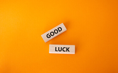 Good luck symbol. Wooden blocks with words Good luck. Beautiful orange background. Business and Good luck concept. Copy space.