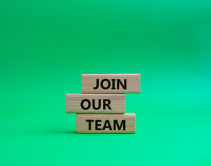 Join our team symbol. Wooden blocks with words Join our team. Beautiful green background. Business and Join our team concept. Copy space.