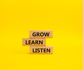 Grow Learn Listen symbol. Concept words Grow Learn Listen on wooden blocks. Beautiful yellow background. Business and Grow Learn Listen concept. Copy space