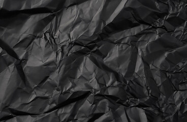 Black creased crumpled paper background grunge texture background