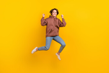 Fototapeta na wymiar Full body photo of attractive youngster lady jumping crazy active black friday advertisement poster isolated on yellow color background