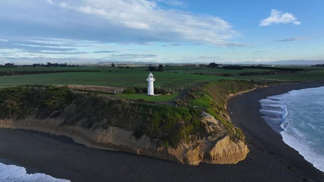 Popular coastal scenic of Tuhawaiki Point, Jack's Lighthouse, Timaru, New Zealand. Aerial orbit.