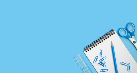 Banner with school supplies on a blue background. Back to school. Flatlay. Top view. Copy space.