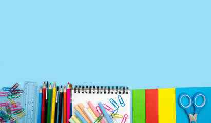 School composition with colorful school supplies on blue background. Back top school concept. Top...